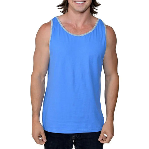 A smiling person with long brown hair wears the Spiritex | Sustainable Apparel Jersey Tank, made from 100% organic cotton in light blue, and black pants, standing against a plain white background.