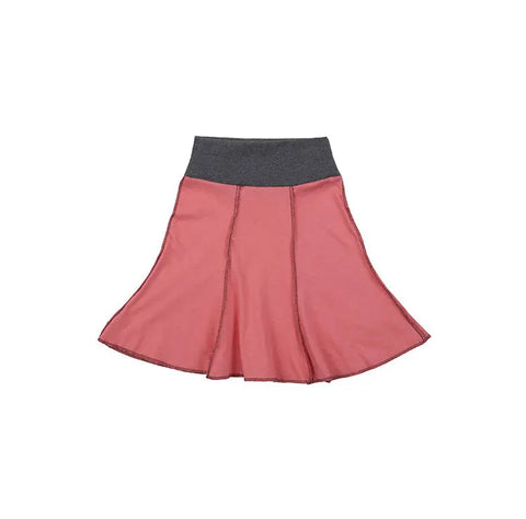 The Short Seamed Flare Skirt by Spiritex | Sustainable Apparel is a pink childrens skirt made from 100% organic cotton grown and sewn in the USA, featuring a wide dark gray elastic waistband and visible vertical seams. Displayed on white.