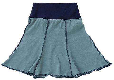 The Short Seamed Flare Skirt by Spiritex | Sustainable Apparel features a dark navy waistband, light blue panels with visible dark stitching, and is made from 100% organic cotton grown and sewn in the USA.