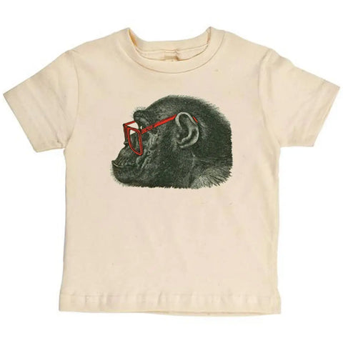 The Spiritex Gorilla in Glasses Graphic Tee is a cream-colored childrens organic t-shirt featuring a profile illustration of a chimpanzee wearing red glasses.