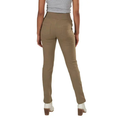 A person is seen from the back wearing Spiritex | Sustainable Apparels Lightweight Saratoga Pants in khaki, a gray sleeveless top, white socks, and beige heeled shoes against a white background.