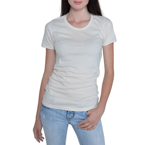 A woman wears the Spiritex | Sustainable Apparel Short Sleeve Favorite Crewneck Tee (W) in off-white with light blue jeans, standing against a white background with one hand in her pocket and the other by her side.