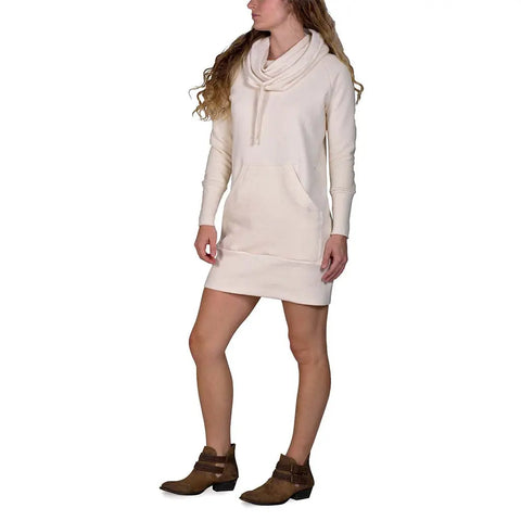 A person wears the RAD Sweatshirt Dress by Spiritex | Sustainable Apparel in cream, featuring long sleeves, a cowl neck, and a front pocket, styled with brown ankle boots against a white background.