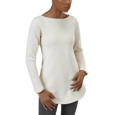 A person wears the Spiritex Maddi Tunic Sweatshirt in off-white organic cotton with dark pants, posing against a plain white background—one hand on their hip and the other by their side.