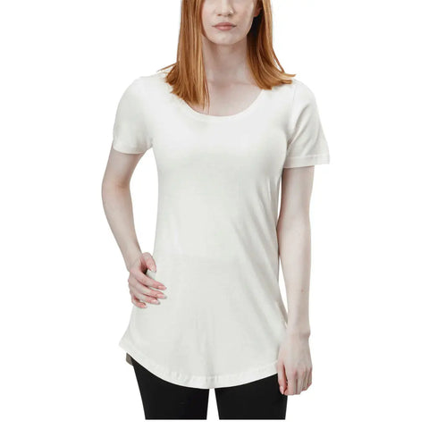 A woman with straight red hair wears the Spiritex Skyland Short Sleeve Tunic Tee in white and black pants, standing against a white background.