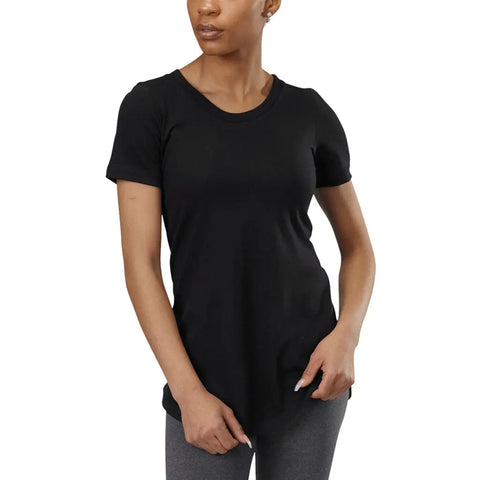 A person wears the Skyland Short Sleeve Tunic Tee by Spiritex | Sustainable Apparel in black with gray leggings, standing against a plain white background, one hand relaxed and the other touching the shirts hem.