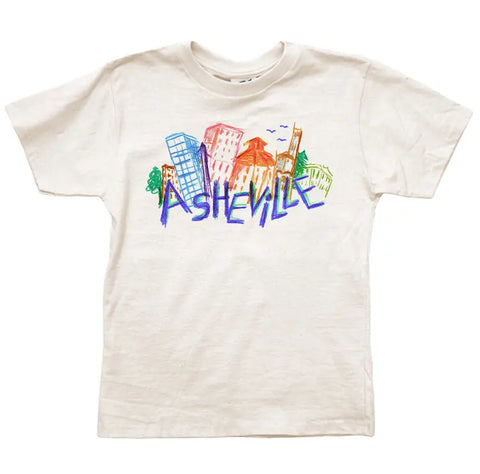 The Asheville Crayon Skyline Graphic Tee by Spiritex | Sustainable Apparel is a white youth shirt made from soft, organic cotton, featuring colorful, hand-drawn buildings and trees above bold “Asheville” graffiti-style lettering.