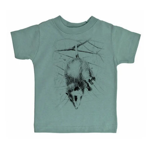 The Spiritex Possum Graphic Tee is a green organic cotton kids’ shirt featuring a black line drawing of an opossum hanging upside down—ideal for sensitive skin.