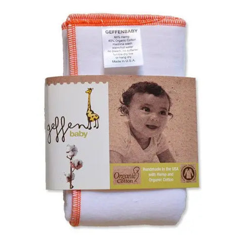 A folded white Geffenbaby prefold diaper with orange trim, shown in packaging featuring a smiling baby and giraffe. Handmade in the USA from organic cotton and super absorbent fleece hemp.