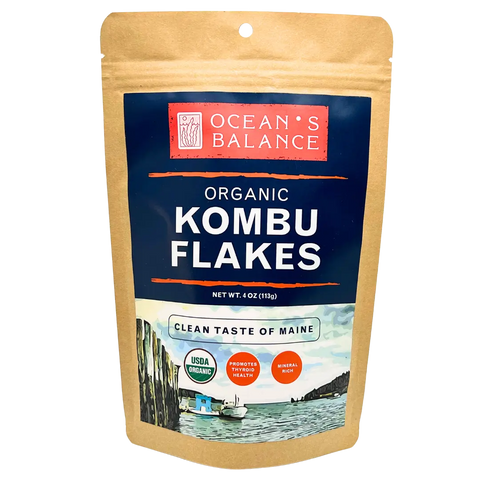 A resealable brown pouch labeled Oceans Balance Organic Kombu Flakes features a coastal design, USDA Organic seal, health icons, and the phrase Clean Taste of Maine on the front.