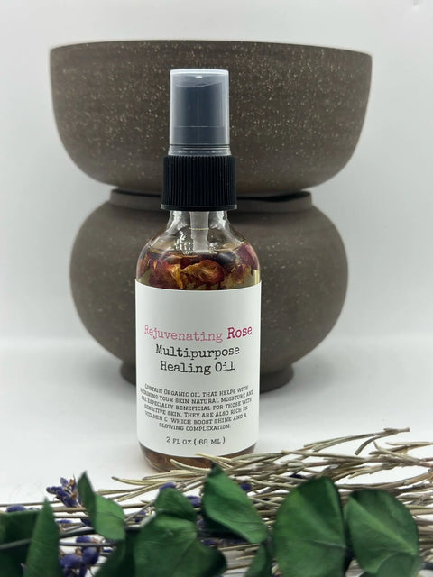 A bottle of Five O Clock Co. Rejuvenating Organic Rose Multipurpose Oil stands before two stacked brown bowls, accented by dried lavender and greenery, showcasing the natural glow this organic oil provides.