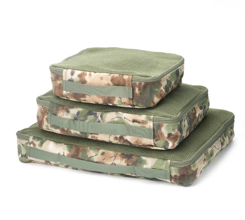 The MIS Organizer Set - Covert Woodland includes three stackable, rectangular packing cubes in assorted sizes with camouflage patterns and green mesh tops, crafted from durable Dupont Cordura Nylon—ideal for travel and outdoor organization.