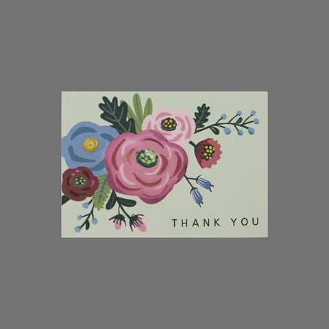 JuLu Cards Pack of 8 Thank You With Flowers in Upper Left (10017) features 3.5 x 5 cards with pink, purple, and green flowers on a light background and “THANK YOU” in black at the lower right. Includes envelopes.