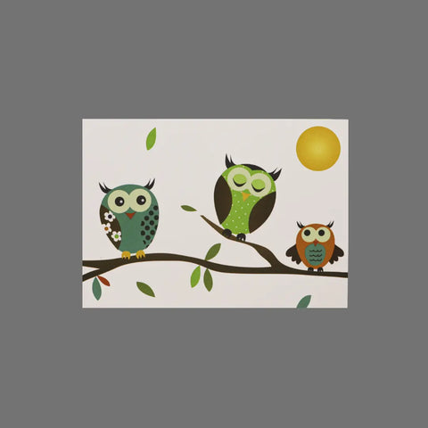 The JuLu Cards Pack of 8 - Three Owls on Branch With Middle Asleep (10046) features a charming illustration of three stylized owls under a yellow sun, on greeting cards with matching envelopes.
