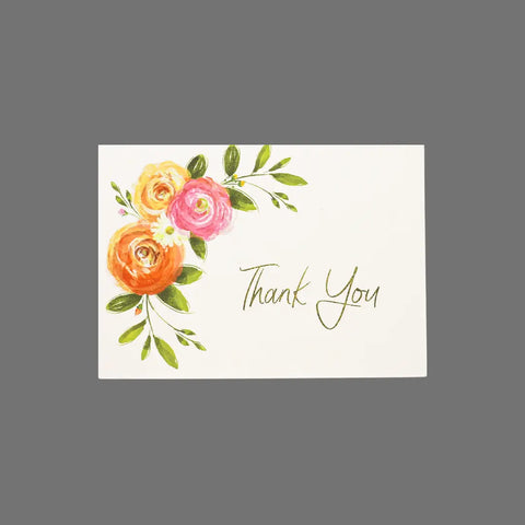 The JuLu Cards Pack of 8 - Thank You With Three Flowers in Corner (10062) features elegant script on white 3.5x5 cards, accented with painted orange, pink, and yellow flowers plus green leaves. Includes envelopes.