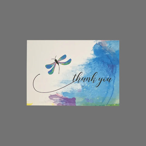 The JuLu Cards Pack of 8 Thank You With Blue Dragonfly (10080) features watercolor blue, green, and purple backgrounds with a vibrant dragonfly and elegant script on 3.5x5-inch cards, including matching envelopes.