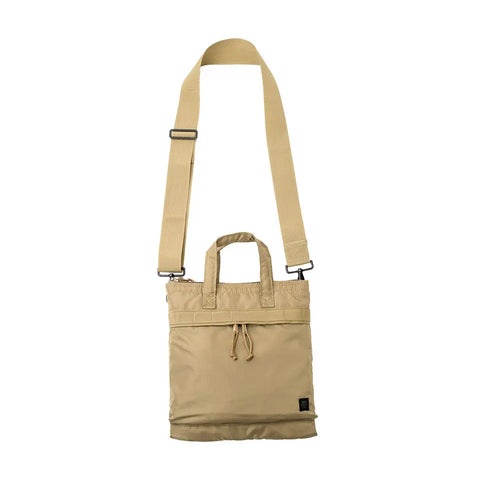 The MIS Padded F Helmet Bag S in Coyote Tan features beige packcloth nylon, a padded main compartment, an adjustable shoulder strap, two short handles, a front zip pocket, and a small black label at the bottom right, shown on a white background.