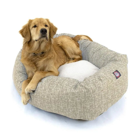 A golden retriever lounges in the Majestic Pet Palette Heathered Sherpa Bagel Dog Bed, featuring a light gray plush design with spine support, raised sides for coziness, a white cushion, and machine-washable for easy care.