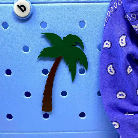 Decorate your Simply Southern Bags with BOGLETS Beach Charm Accessories by Chatelet Manufacturing—a palm tree-shaped magnet, white b button, and blue patterned cloth, perfect as fun beach-inspired charms.