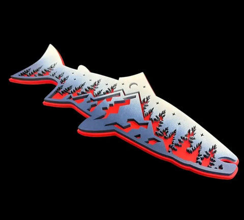 The Patriotic Mountain Trout Sign by B. James Design & Woodwork features a stylized fish silhouette with trees, mountains, and a crescent moon in blue, white, and red—ideal home decor for fishing fans on a sleek black background.