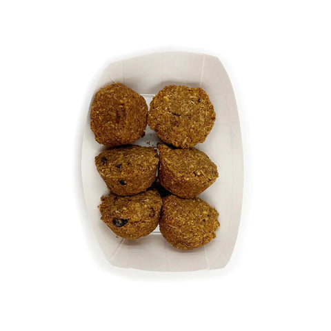 Six Brewnola balls by Brewscuits, made with sustainable ingredients, arranged in a white rectangular paper tray and viewed from above on a plain white background.