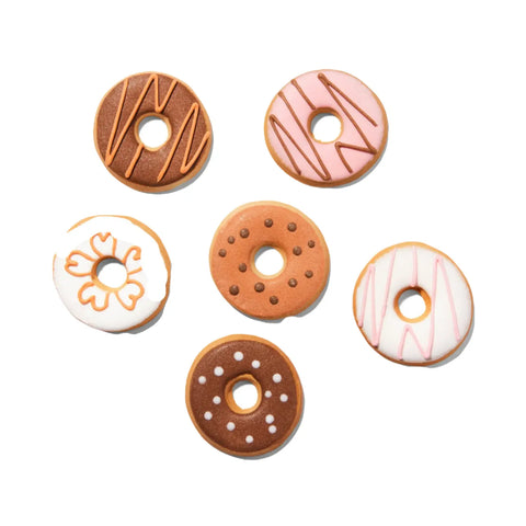 The Dogtown Bakery Donut Cookie Box features six artisan cookies with pink, brown, and white icing patterns. Each round cookie has a center hole, resembling a donut, and is arranged on a white background.