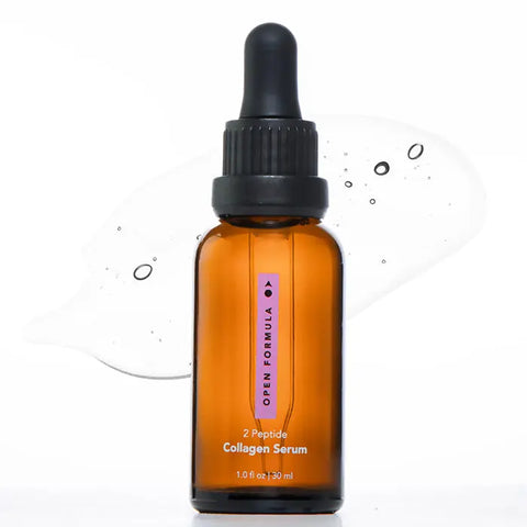 Amber dropper bottle of Open Formula Collagen Peptide Serum on a white surface with a clear serum splash in the background, designed to improve skin texture and boost hydration for a radiant look.