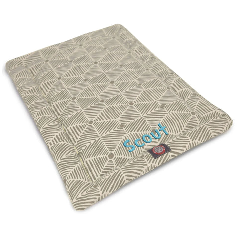 The Majestic Pet Charlie Crate Mat - Personalized is a rectangular, light gray and white geometric dog bed with Scout embroidered in blue. Machine washable for easy care, it combines style and comfort for your pet.