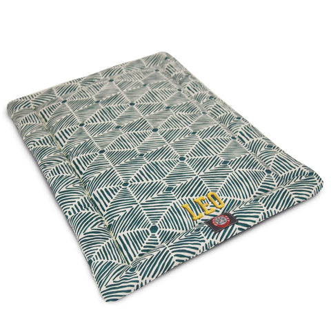 The Majestic Pet Charlie Crate Mat - Personalized features a green and white leaf pattern, yellow LEO embroidery, and is machine washable—adding comfort and style to any rectangular crate.
