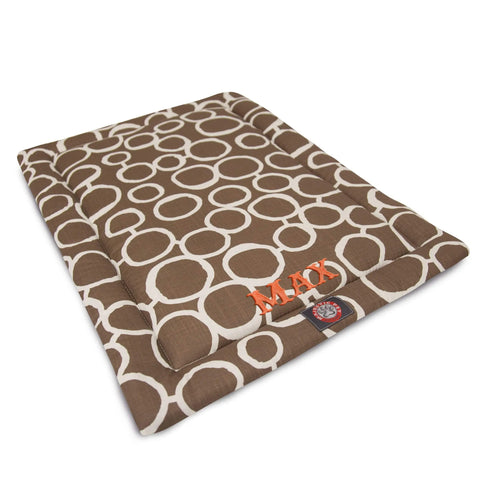 The Majestic Pet Fusion Crate Mat - Personalized features a brown rectangular design with white circles, orange MACY embroidery, and a small front label. Filled with premium polyester batting and machine washable for easy care.