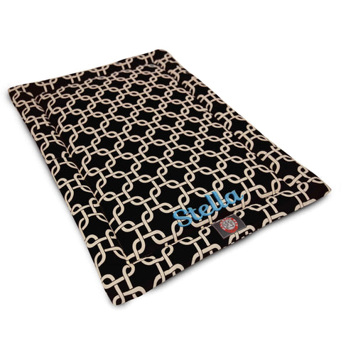 The Majestic Pet Links Crate Mat - Personalized is a rectangular black mat with a white interlocking chain pattern, featuring your dog’s name and a red paw print logo. Washable and stylish, it adds comfort to your pup’s space.