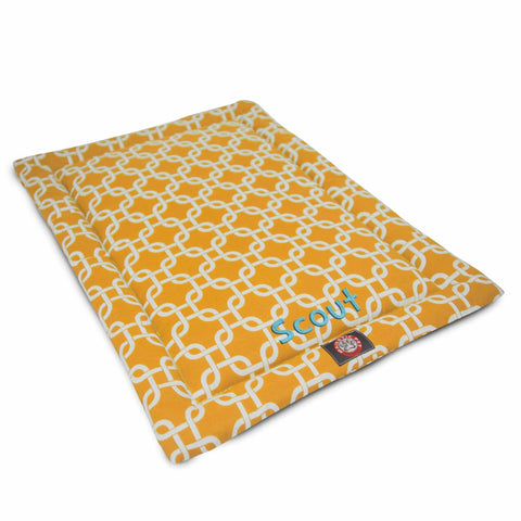 The Majestic Pet Links Crate Mat - Personalized is a yellow rectangular polyester dog bed with a white geometric chain pattern, blue Scout embroidery, and a red logo tag—ideal as a washable pet mattress or crate mat.