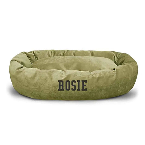 The Majestic Pet Villa Bagel Dog Bed - Personalized, in round olive green polyester micro-velvet, features ROSIE printed in bold black on the front. Plush, water-resistant, and comfortable for daily use.