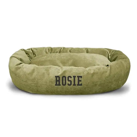 The Majestic Pet Villa Bagel Dog Bed - Personalized in olive green features water-resistant polyester micro-velvet, soft cushioned sides, and has ROSIE printed in bold black letters on the front.