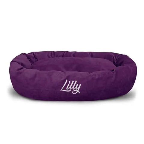 Majestic Pet Villa Bagel Dog Bed - Personalized: Plush, oval-shaped, purple micro-velvet with Lilly embroidered in white on the front.