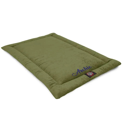 The Majestic Pet Villa Crate Mat - Personalized is a rectangular olive green dog mat with soft edges, featuring Archie embroidered in blue on one corner and a logo tag below. Machine washable for easy care and comfort.