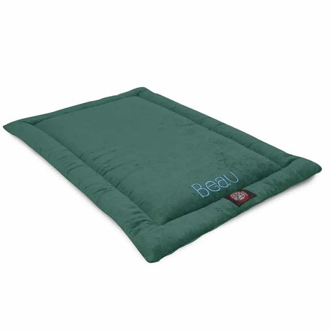 The Majestic Pet Villa Crate Mat - Personalized is a rectangular green polyester dog bed with plush fabric and raised edges. Beau is embroidered in blue on one corner, and a red logo tag is attached to the side. Machine washable.