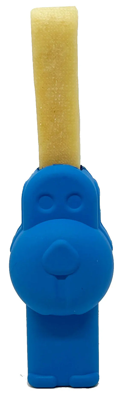 The SodaPup Petz Yak Chew Holder EDispenser, shaped like a blue dog, grips a beige treat stick vertically in its mouth and is shown from the front against a white background.