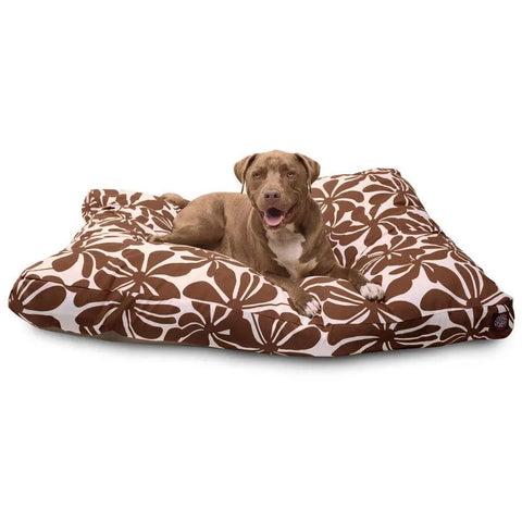 A brown dog lies on the Majestic Pet Plantation Rectangle Dog Bed, featuring a brown and white floral pattern, premium polyester fill, and a washable cover for easy care.
