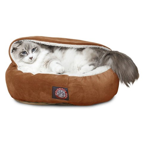 A fluffy gray and white cat is relaxing inside the Majestic Pet Suede Canopy Cat Bed, a brown, soft faux suede bed with a partially covered top for cozy comfort.