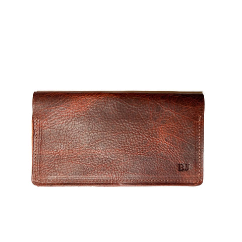 A brown Leather Checkbook Cover by Rogue Industries, featuring a textured American Bison leather surface, a rectangular shape, and the initials BU embossed in the lower right corner.