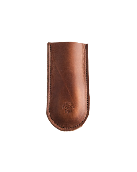 The Skillet Handle Sleeve No. 2002 by Homestead Brand is a brown full grain leather sheath with edge stitching and an embossed logo near the bottom, shown against a white background.