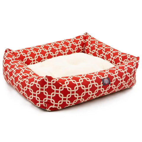 The Majestic Pet Links Luxe Bagel Bed is a stylish, rectangular dog bed with a plush cream cushion and red sides featuring a white interlocking geometric pattern, offering both durability and comfort for your pet.