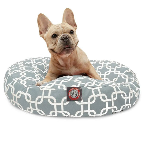A light brown French Bulldog sits on the Majestic Pet Links Round Dog Bed, featuring a removable, gray and white patterned cover, red paw print label, and machine-washable design for easy care.