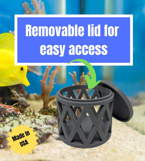 A black REEFSHAPE Aquarium Mushroom Coral Cage by Chatelet Manufacturing is shown open before coral and a yellow fish. Its open design protects coral or anemones while allowing water flow. Removable lid for easy access. Made in USA badge displayed.