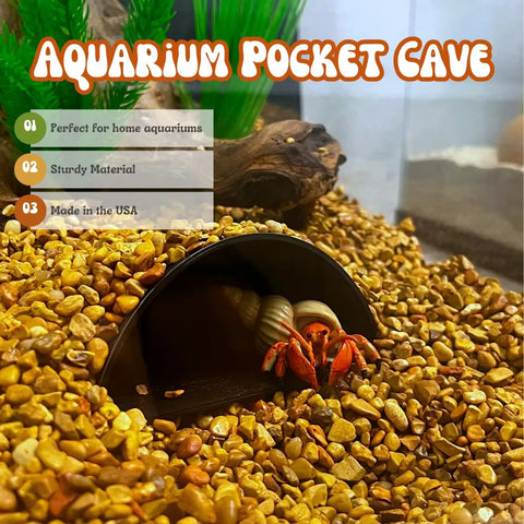 A hermit crab rests in a REEFSHAPE Aquarium or Terrarium Pocket Cave by Chatelet Manufacturing, set on yellow pebbles. Features: minimalist shelter for various pets, sturdy design, and proudly made in the USA.