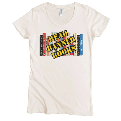 The Spiritex Read Banned Books Graphic Tee (W) is a white organic cotton shirt featuring bold yellow and black READ BANNED BOOKS lettering on illustrated book spines.