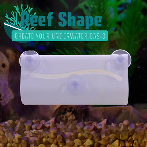 A white Chatelet REEFSHAPE tunnel hide for betta fish or axolotls, with three suction cups, is attached inside an aquarium with gravel and plants. Text: Chatelet Manufacturing REEFSHAPE Tunnel Hide – Made in USA.