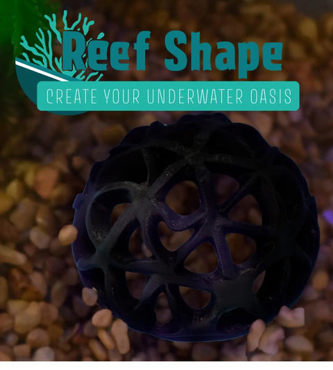 A Chatelet REEFSHAPE Dome Fish or Shrimp Aquarium Hideout by Chatelet Manufacturing, featuring a black geometric design, sits on multicolored gravel. The ReefShape logo and Create Your Underwater Oasis tagline appear on a turquoise background.