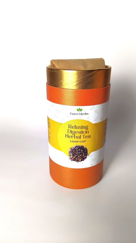 A cylindrical orange container labeled Relaxing Digestion Herbal Tea by Forev'Herbs sits on a white background with a gold lid and loose tea leaf image, highlighting this caffeine-free blend for digestive support.